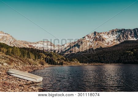 A Boat Resting Ashore The Alpine Waters Of Trout Lake In The Rocky Mountains Near Telluride, Colorad