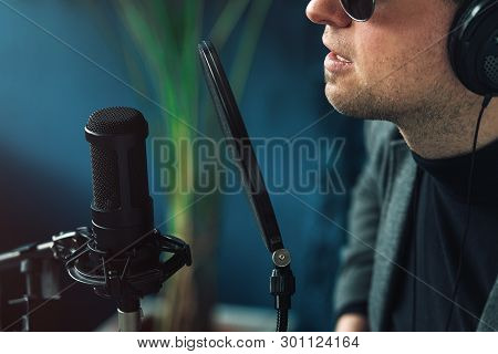 Close Up Of A Man Singer In A Headphones Recording A Song In A Home Studio