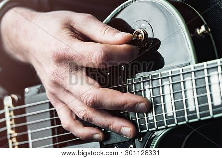 Close Up Shot Of Hands Of Man Playing Electric Guitar