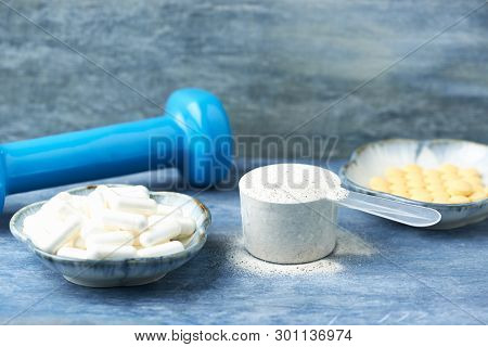 Collagen Powder, Proline Capsules And Vitamin C Tablets. Sports Supplements. Rustic Wooden Backgroun