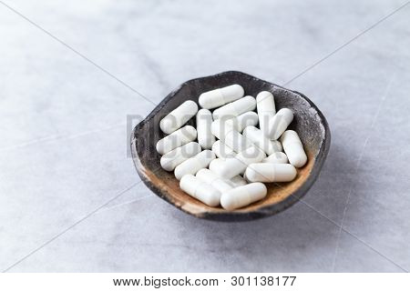 Tribulus Terrestris Extract. A Dietary Supplement. Bright Stone Background.  Copy Space.