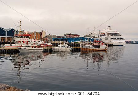 Hammerfest, Norway - January 21, 2010: Ships And Boats In Sea Dock On Grey Sky. Water Transport And 