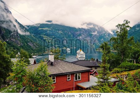 Geiranger, Norway - January 25, 2010: Adventure, Discovery, Journey. Ship In Norwegian Fjord On Clou