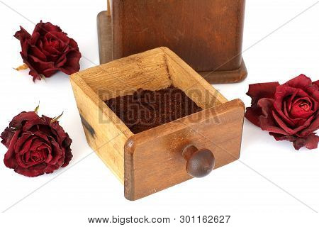 Manual Coffee Grinder With Roses On A White Background. Antiquary
