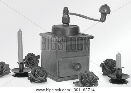Manual Coffee Grinder With Roses On A White Background. Antiquary