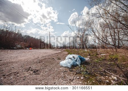 A Package Of Plastic Garbage Lies In The Forest On A Forest Road, Pollution Of Nature, Garbage And N