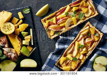 Delicious Pineapple And Apple Sweet Tart In Rectangular Tart Pans On A Concrete Table With Kitchen T