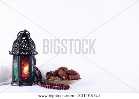 Ramadan Food And Drinks Concept. Ramadan Lantern With Arabian Lamp, Wood Rosary, Tea, Dates Fruit An