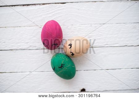 Easter Eggs On A White Wooden Background.