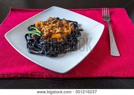 Black Pasta With Cuttlefish Ink. Pasta Of Durum Wheat Semolina With Squid Ink With Beef And Sweet Pe