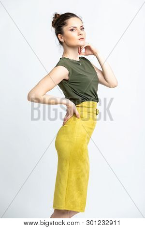 Model In Green Blouse, Yellow Suede Skirt With Yellow Belt, Isolated On White Background.
