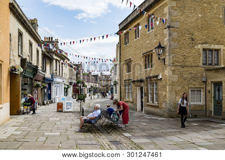 Corsham, Uk - July 17: A Person Rides His Bike In A Street In Corsham, An Old Village In South Of En