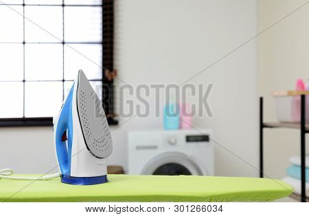 Modern Clothes Iron On Board In Laundry Room