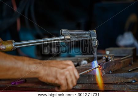 Closeup Machinist Hand Bending The Steel By Torch  In Metalworking Factory, Lathe Grinding Metalwork