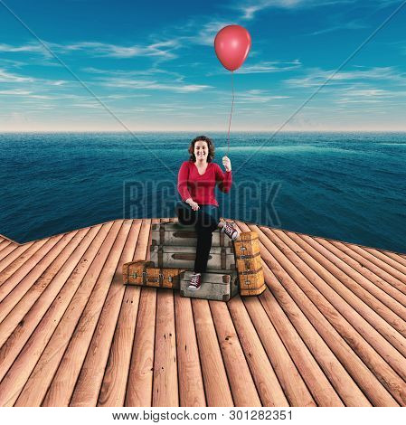 Woman Holds A Balloon On A Lugagges By The Sea. The Concept Of Summer Time.