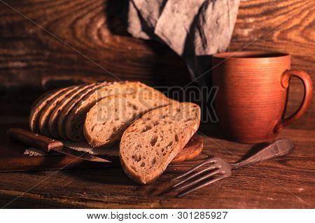 Rural Still Life With Homemade Bread On Rustic Background In The Morning Light