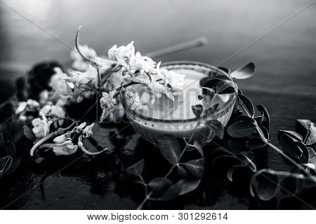 Ayurvedic Herb Drumstick Flowers Along With Some Leaves On Wooden Surface Along With Its Paste In A 