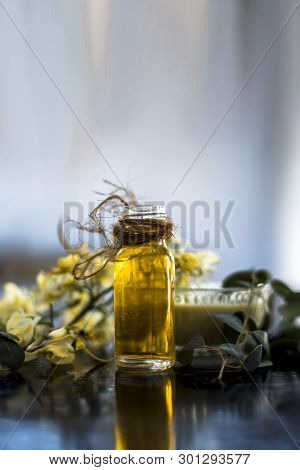 Bunch Of Flowers Of Drumstick On Wooden Surface Along With Its Extracted Essential Concentration Or 
