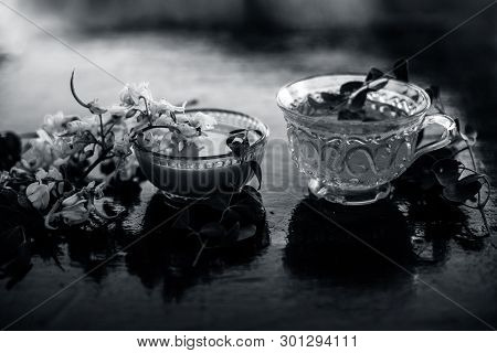 Bunch Of Flowers Of Drumstick On Wooden Surface Along With Its Extracted Tea And Paste Of Flowers In