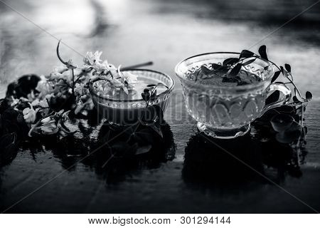 Bunch Of Flowers Of Drumstick On Wooden Surface Along With Its Extracted Tea And Paste Of Flowers In