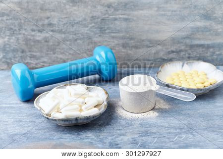 Collagen Powder, Proline Capsules And Vitamin C Tablets. Sports Supplements. Rustic Wooden Backgroun