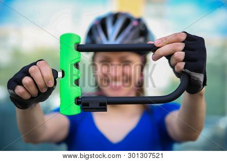 Girl with bicycle  lock. Bicycle U- lock. Bike protection