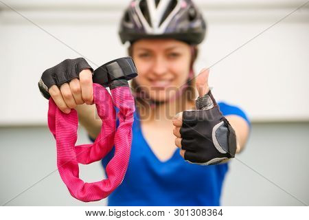 Girl with bicycle  lock. Bicycle lock. Bike protection