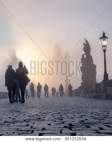 Prague, Czech Republic - March 27 2016: Spectators Watch The Dense Fog On Charles Bridge On The Brig