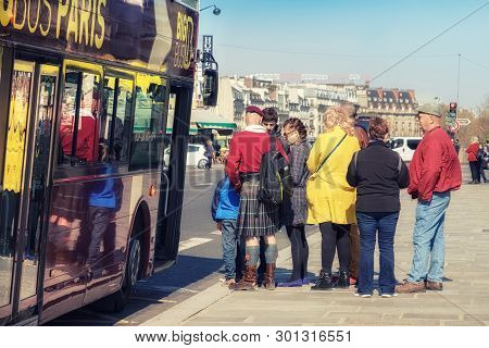 Paris, France - April 20, 2016: Tourists Board Sightseeing Bus In Paris City Senter. Paris Is One Of