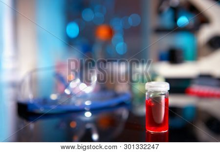 Red Liquid Sample In Plastic Vial On A Table In Biological Laboratory, Shallow Dof, Focus On The Via