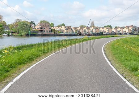 Empty Curved Road On A Dam In The Dutch Countryside, Capelle Aan Den Ijssel, Netherlands