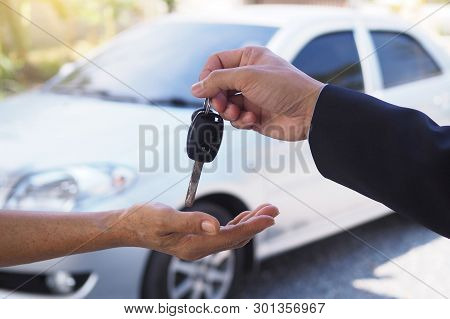 The Car Salesman And The Key To The New Owner.