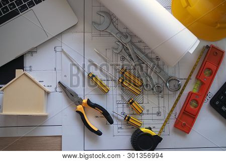 The Desk Of The Contractor And Engineer With Equipment And Flowcharts
