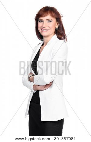 A portrait of a beautiful woman wearing classic clothes and posing over the white background in the studio. Beauty, fashion, business.