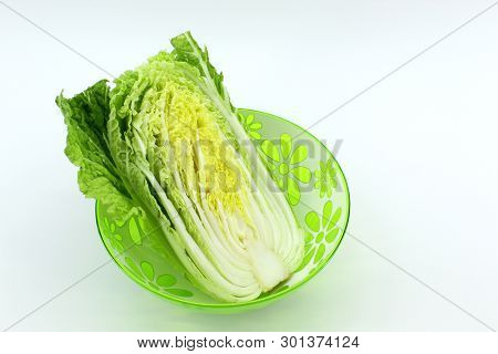In The Center There Is A Plate With Chinese Salad Cabbage. Light Background. There Are Shadows