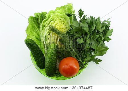 In The Center Is A Beautiful Deep Plate With Vegetables And Herbs: Green Onions, Dill, Parsley, Two 