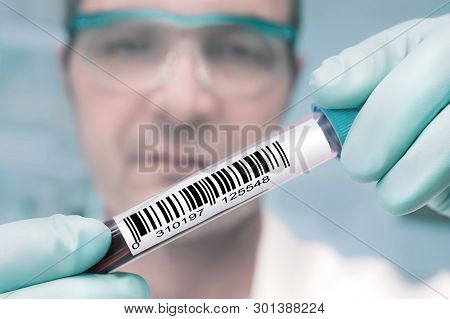 Tech With A Medical Sample Labeled With A Barcode