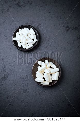 Glutamine And Bcaa Amino Acids. Nutrition For Bodybuilding. Fitness Supplements On Black Stone Backg