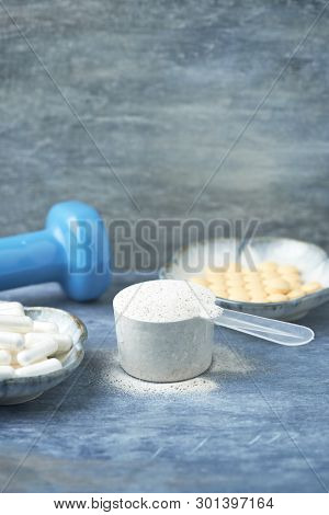 Collagen Powder, Proline Capsules And Vitamin C Tablets. Sports Supplements. Rustic Wooden Backgroun