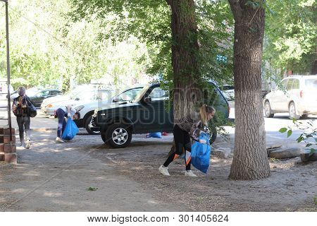 Plogging. Young People Run And Collect Garbage In Bags On The Streets Of Saratov, Russia, June 10, 2