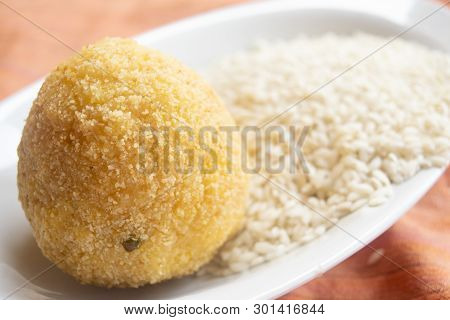 Sicilian Fried Arancino Laid On A Bed Rice