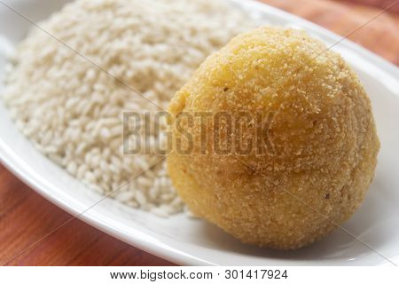 Sicilian Fried Arancino Laid On A Bed Rice