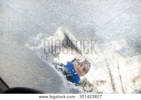 Scraping Ice From The Car Window In Winter Time