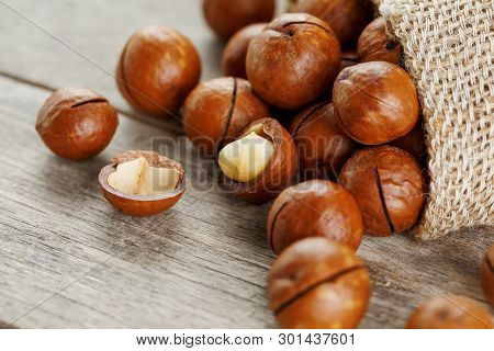 Macadamia Nut On A Wooden Table In A Bag, Closeup, Top View