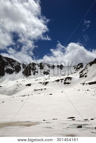 Frozen Lake Covered With Snow, Sunlit Mountain Pass And Blue Cloudy Sky At Spring. Turkey, Kachkar M