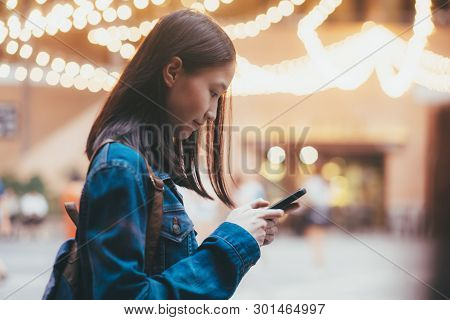Teen Girl Using Mobile Phone To Chat And Send Message.