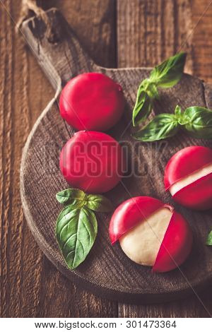 Small Snack Cheeses On The Wooden Board