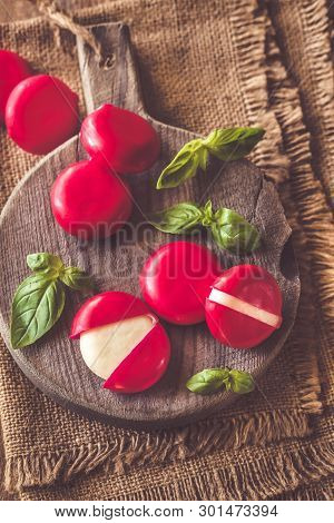 Small Snack Cheeses On The Wooden Board