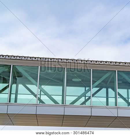 Square Looking Up At An Empty Skybridge With A Cloudy Blue Sky In The Background
