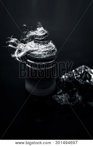 Raw Organic Amli Or Tamarind Or Imli In A Clay Bowl On Wooden Surface With Its Extracted Herbal Esse